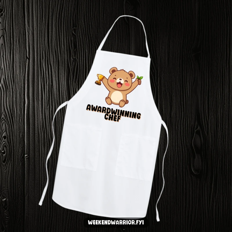 Funny apron featuring a joyful bear cub raising a small leaf trophy, perfect for kitchen adventures and celebrations.