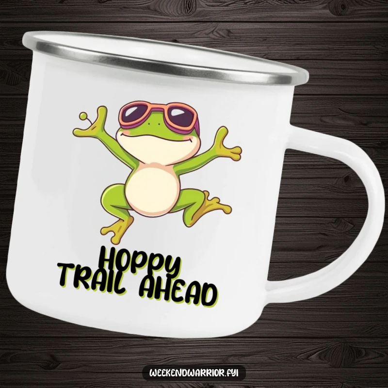 Funny camping mug with a smiling frog in goggles, celebrating a successful jump in an outdoor setting.