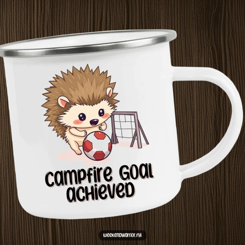 Funny camping mug showing a determined hedgehog rolling a small ball towards a makeshift goal, perfect for outdoor fun.