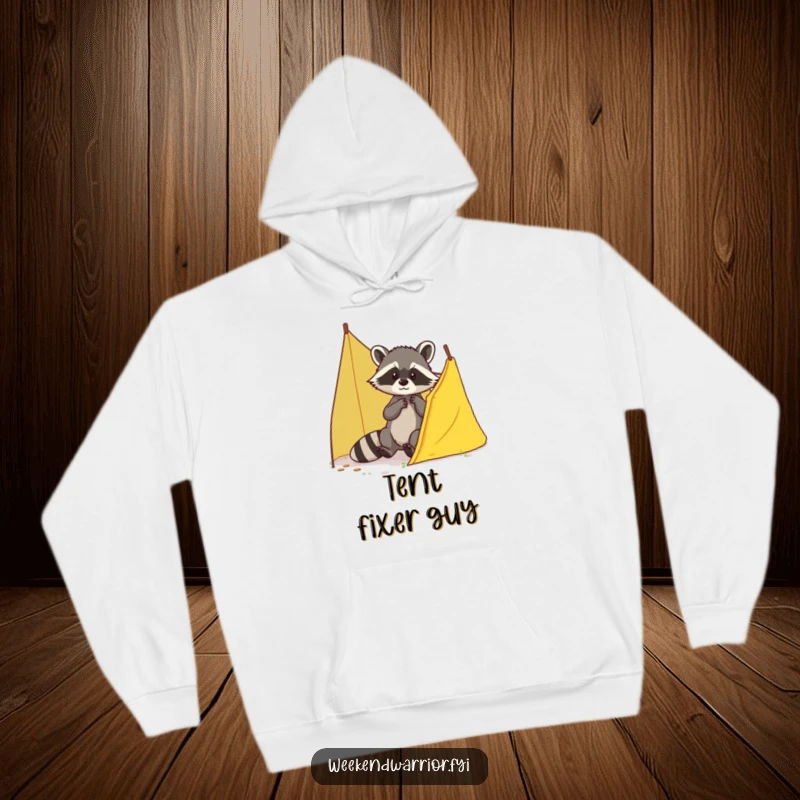 Funny Raccoon Hoodie showcasing a brave raccoon patching up a small tear in a tent, ideal for cozy, humorous wear.