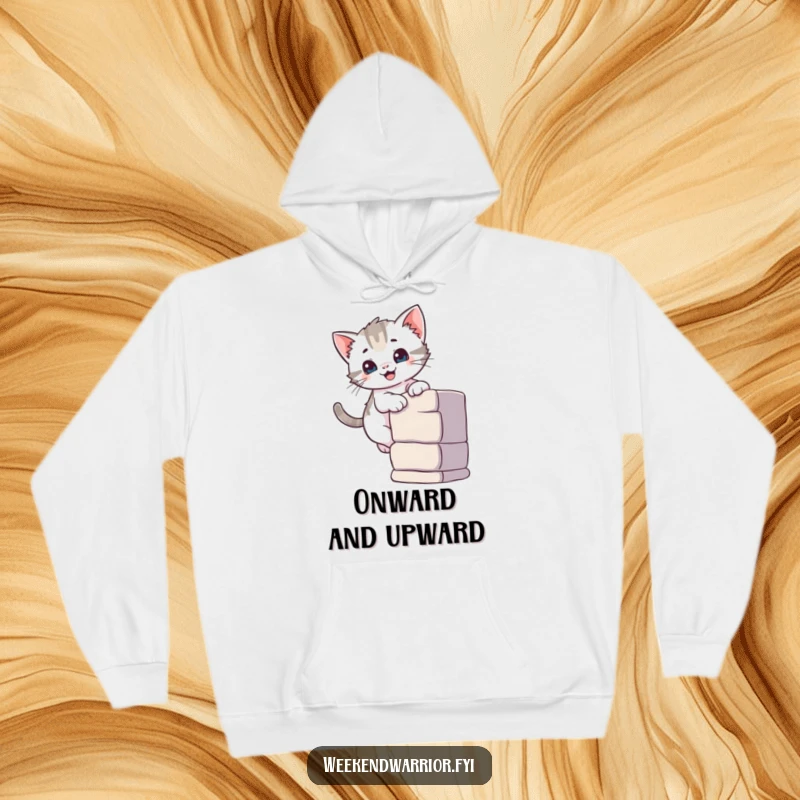 Funny hoodie graphic of a curious kitten with a smile confidently ascending a small climbing wall, showing agility.