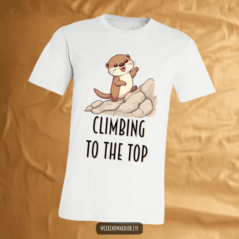Funny t-shirt showcasing a happy otter triumphantly scaling a rocky mountain, paws gripping tightly, with a beaming smile.
