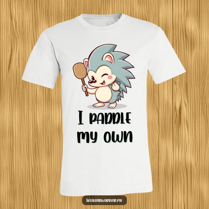 Funny hedgehog t-shirt showcasing a happy hedgehog character expertly wielding a small paddle, perfect for outdoor enthusiasts.