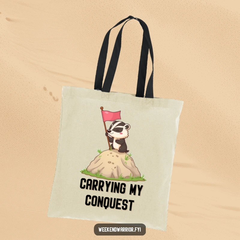 Funny badger flag planting tote bag showing a determined badger triumphantly planting a flag on a small hill, perfect for carrying essentials.